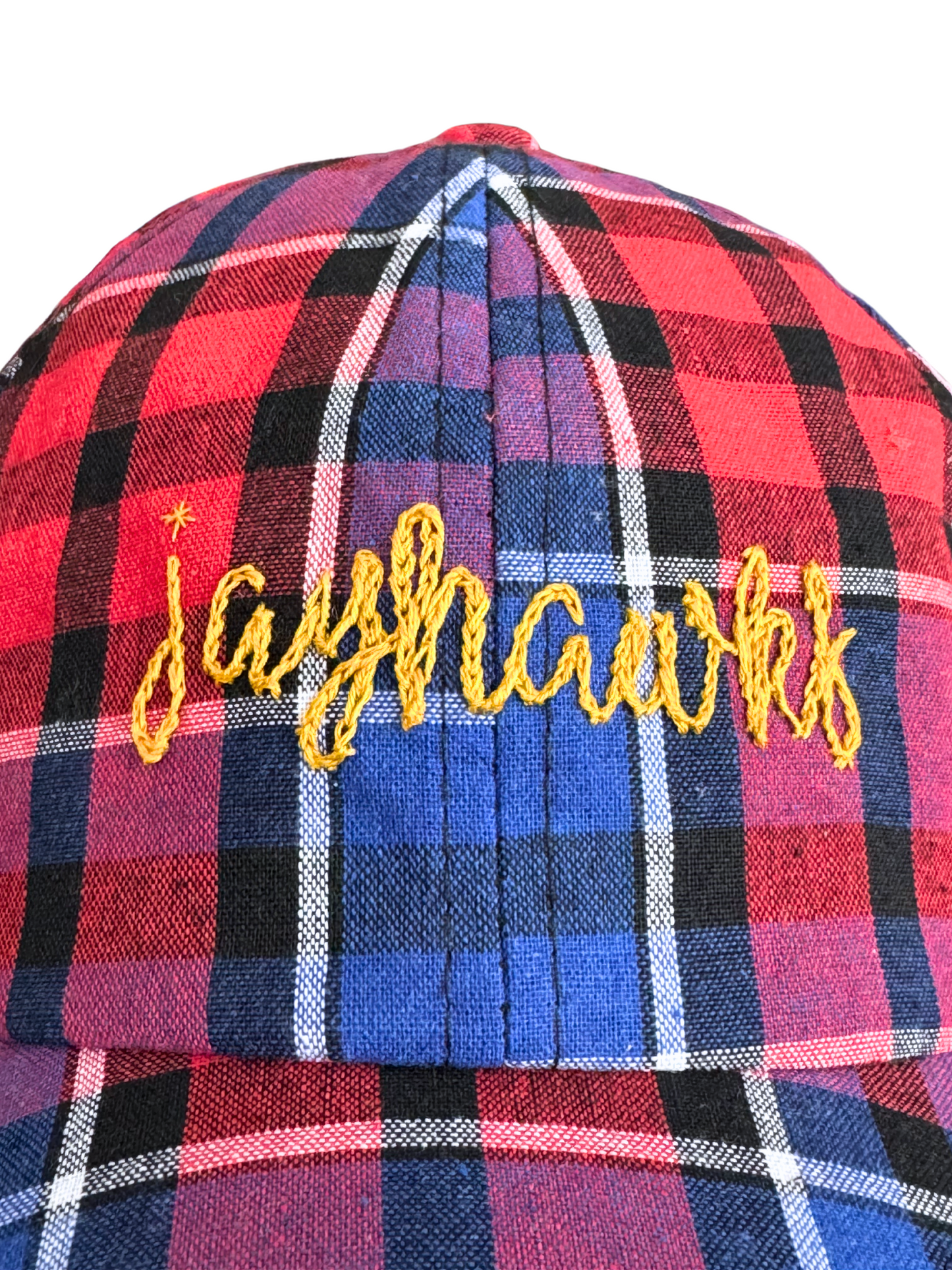 Hand-embroidered "Jayhawks" design on red and blue plaid hat.

