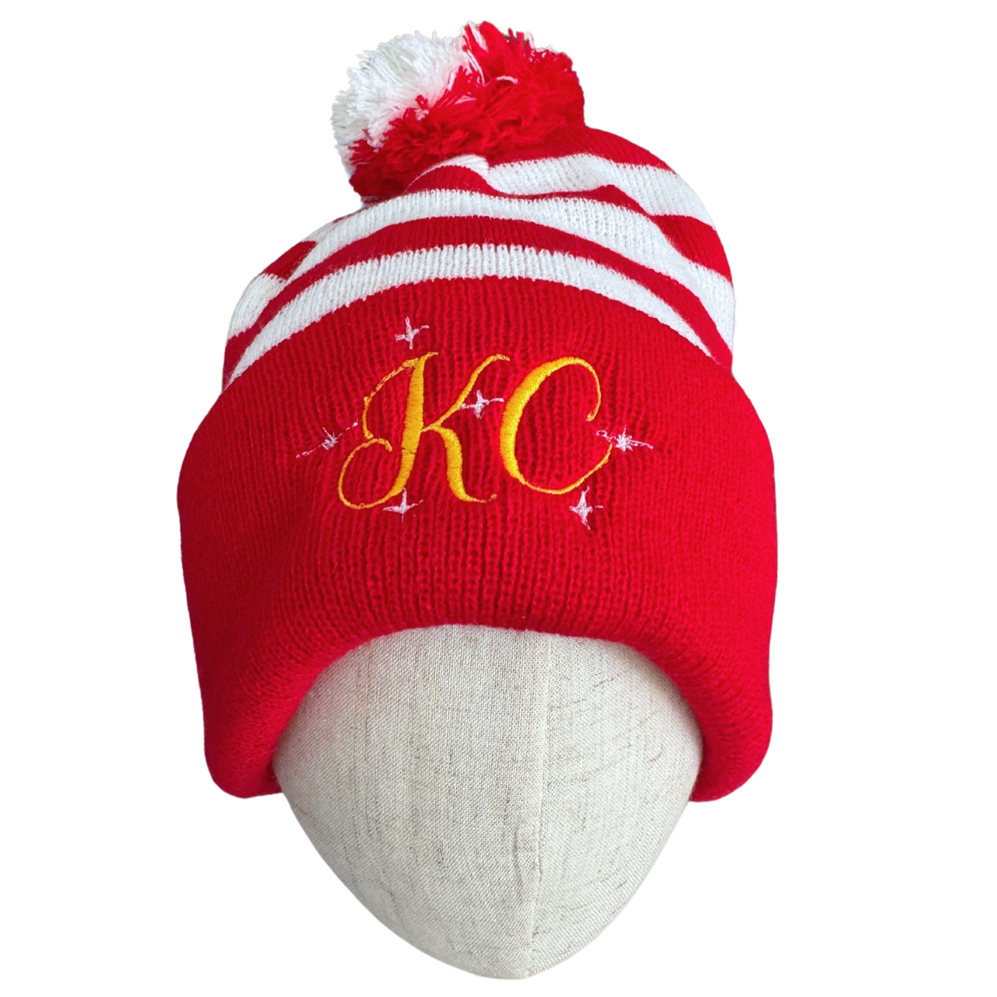 Red and white striped beanie with red and white pom-pom and gold "KC" embroidery with sparkle accents, adult size, festive Chiefs hat.