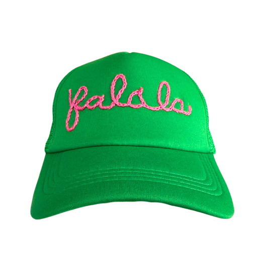 Bright green hat with "Fa La La" pink embroidery in playful cursive.

