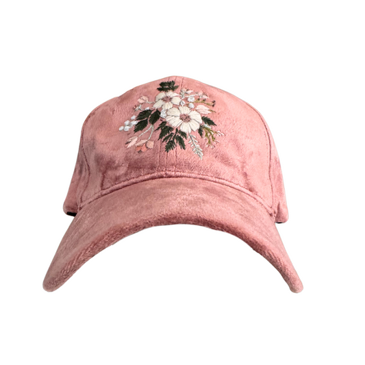 Hand-embroidered floral design on a blush pink velvet hat with white and blush flowers.