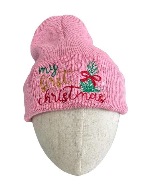 Pink beanie with "My First Christmas" embroidery, featuring a Christmas tree with a red bow and festive lettering for baby wear.

