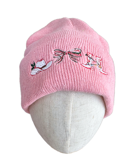 Pink beanie with embroidered cowboy hat, Christmas bow, and festive boots adorned with holiday lights.

