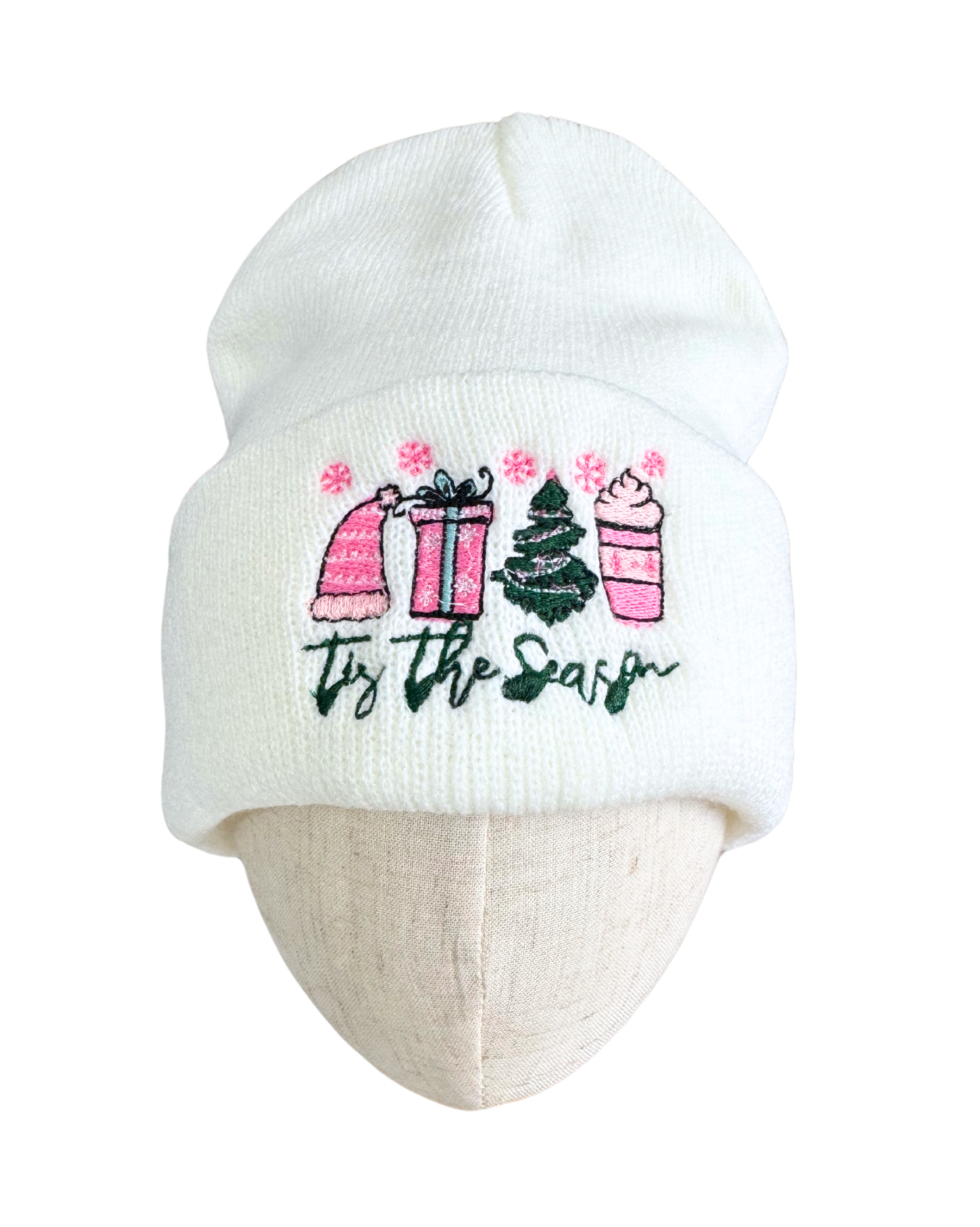 Season white embroidered beanie with festive pink and green motifs.