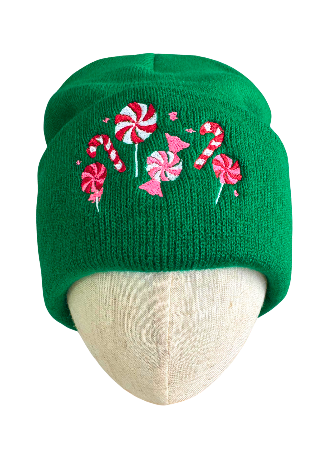 Green beanie with candy cane and peppermint embroidery in red, pink, and white, showcasing festive holiday designs.

