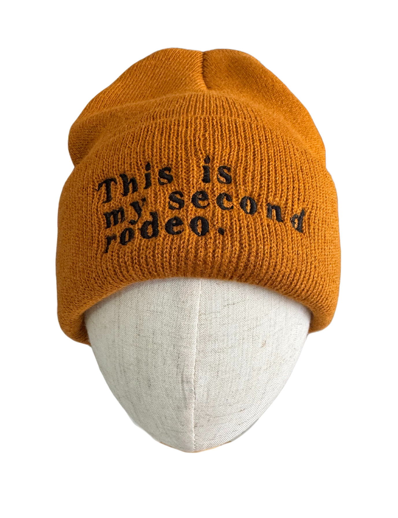 Dark orange beanie with "This is my second rodeo" embroidered in black.