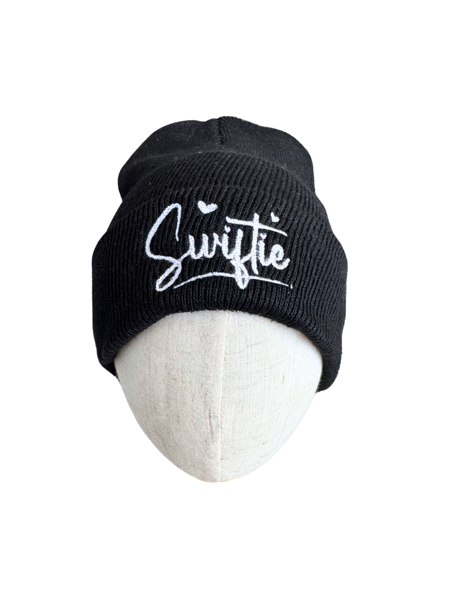 Black beanie with white "Swiftie" embroidery design.

