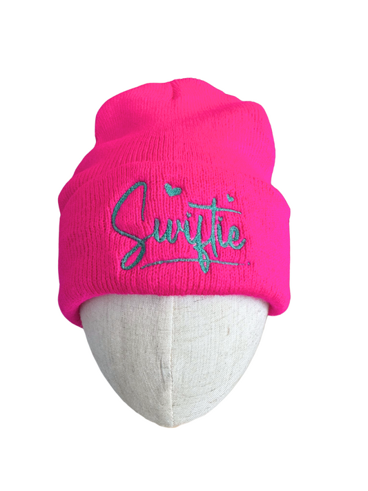 Hot pink beanie with teal "Swiftie" embroidery.

