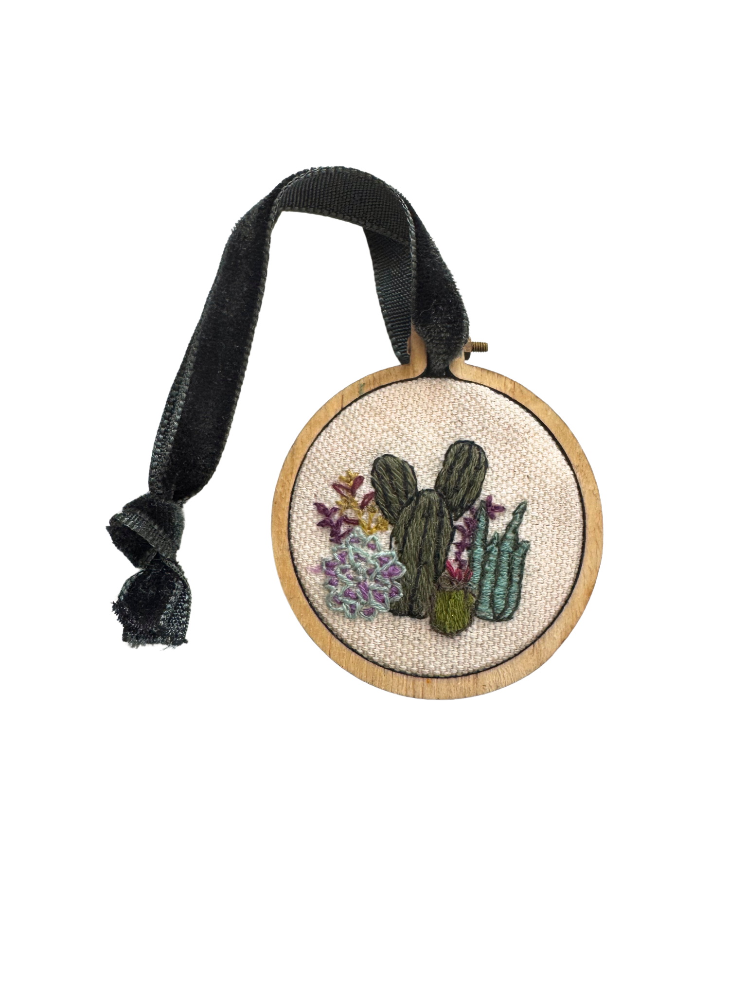 Hand-embroidered cactus ornament with velvet ribbon on wood hoop for holiday decor.