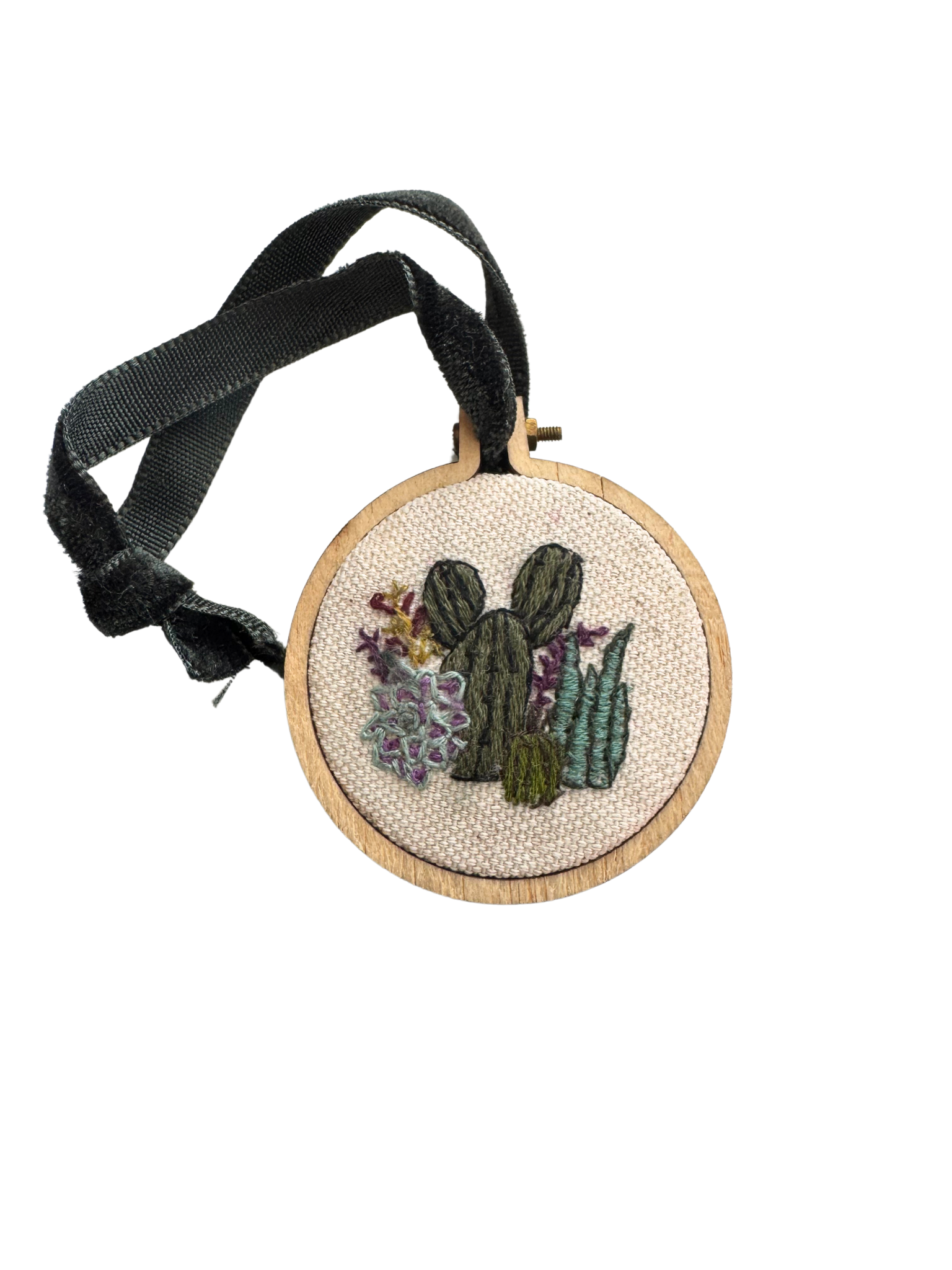 Hand-embroidered cactus ornament with wooden frame and velvet ribbon.