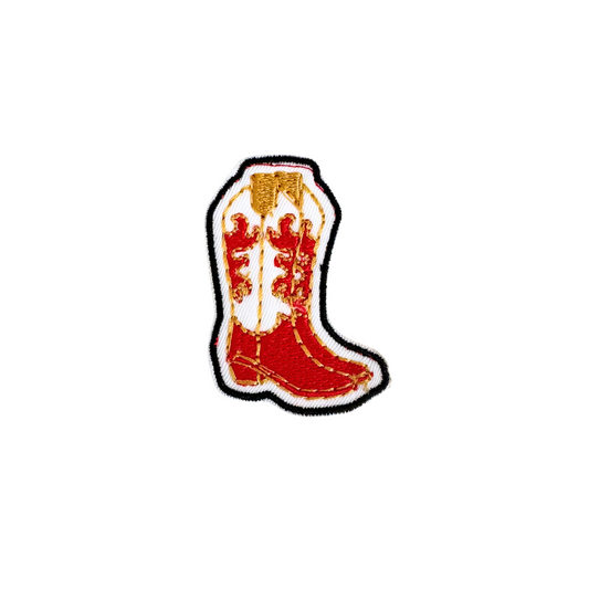 Red cowboy boot iron-on patch with gold and white embroidery.