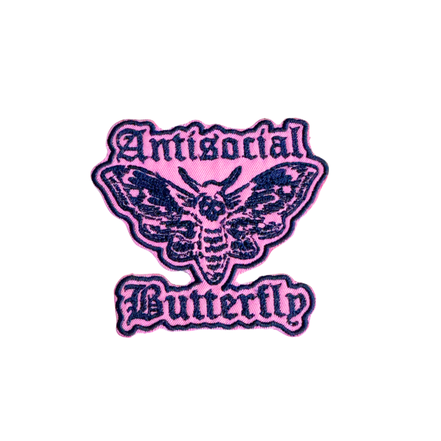 Close-up of the Antisocial Butterfly embroidered patch featuring a gothic-inspired butterfly/moth on a pink background.
