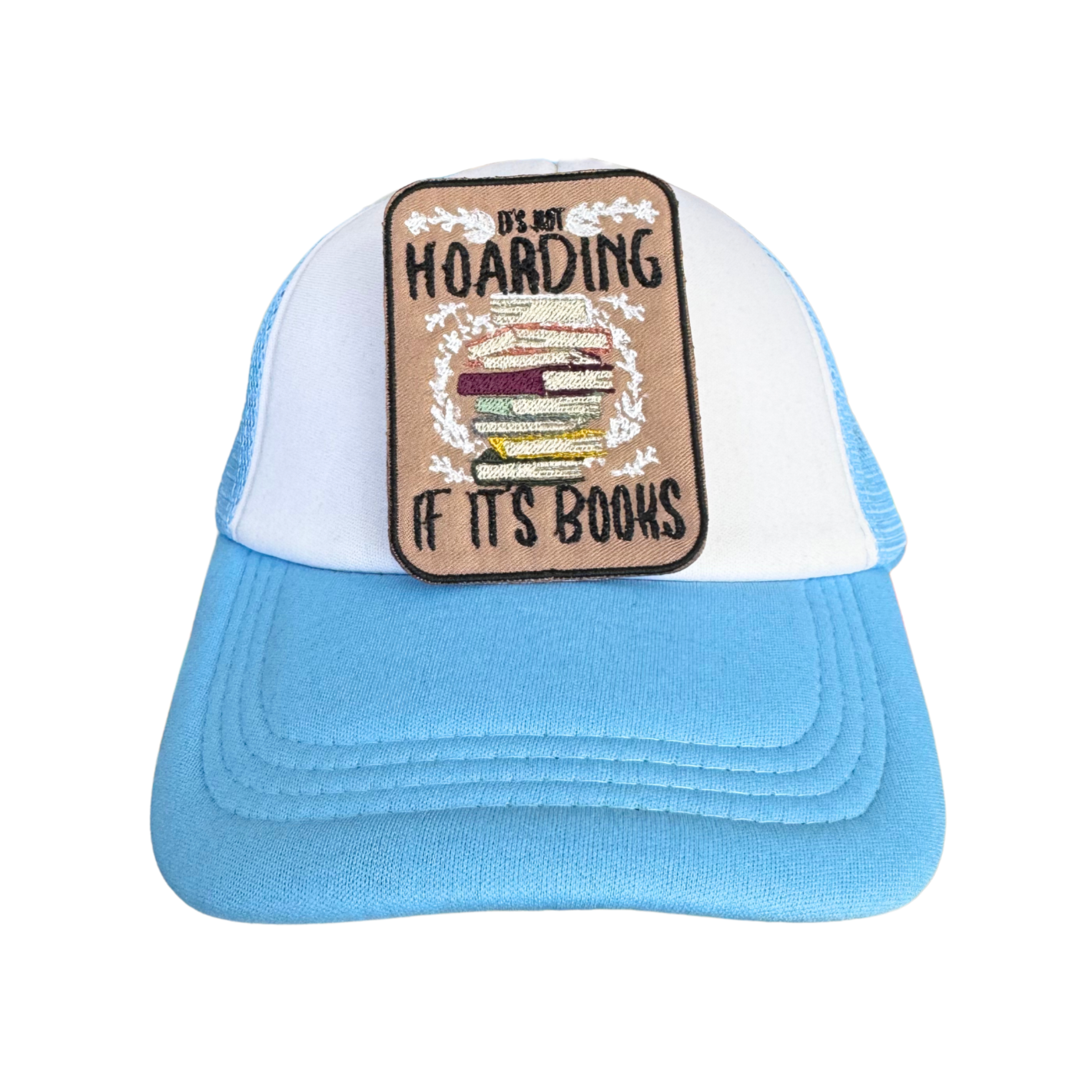 White and blue trucker hat featuring the "It's Not Hoarding If It's Books" embroidered patch, perfect for book lovers.

