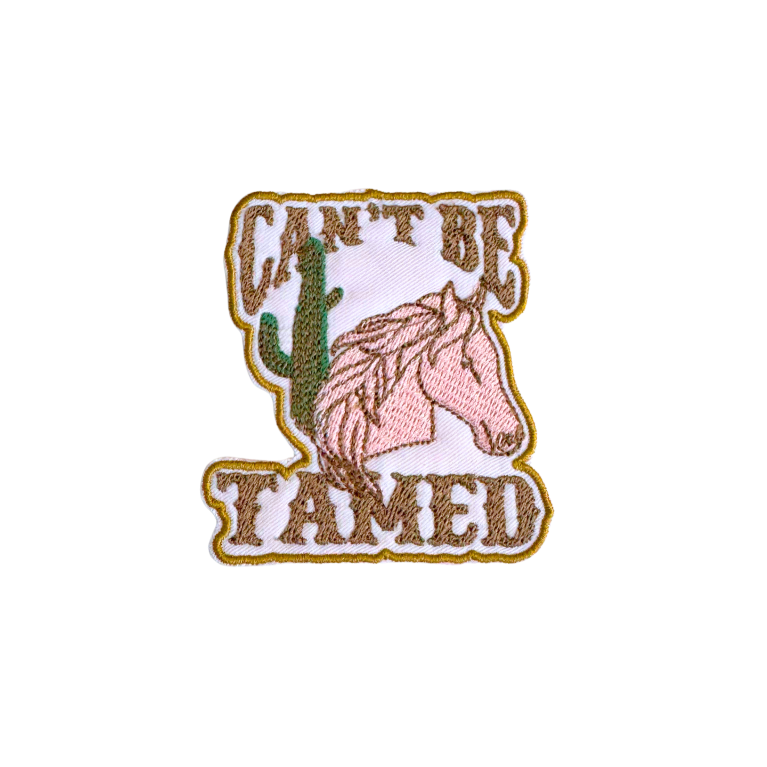 Embroidered "Can't Be Tamed" patch featuring a horse and cactus, Western cowgirl aesthetic.
