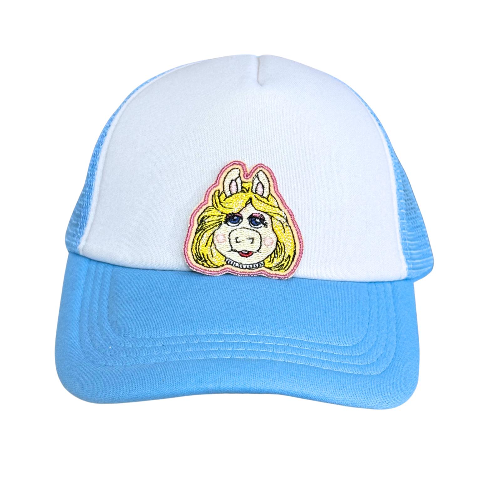 Light blue and white trucker hat with an embroidered blonde pig patch attached.

