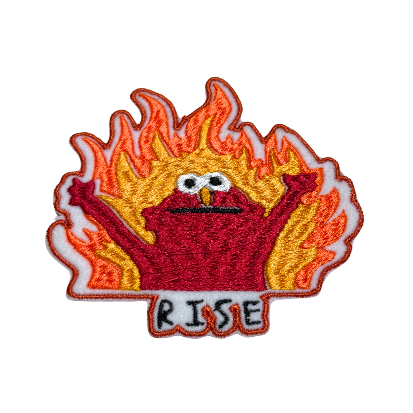 Embroidered patch featuring a chaotic red creature with raised arms engulfed in flames, with "RISE" text below.
