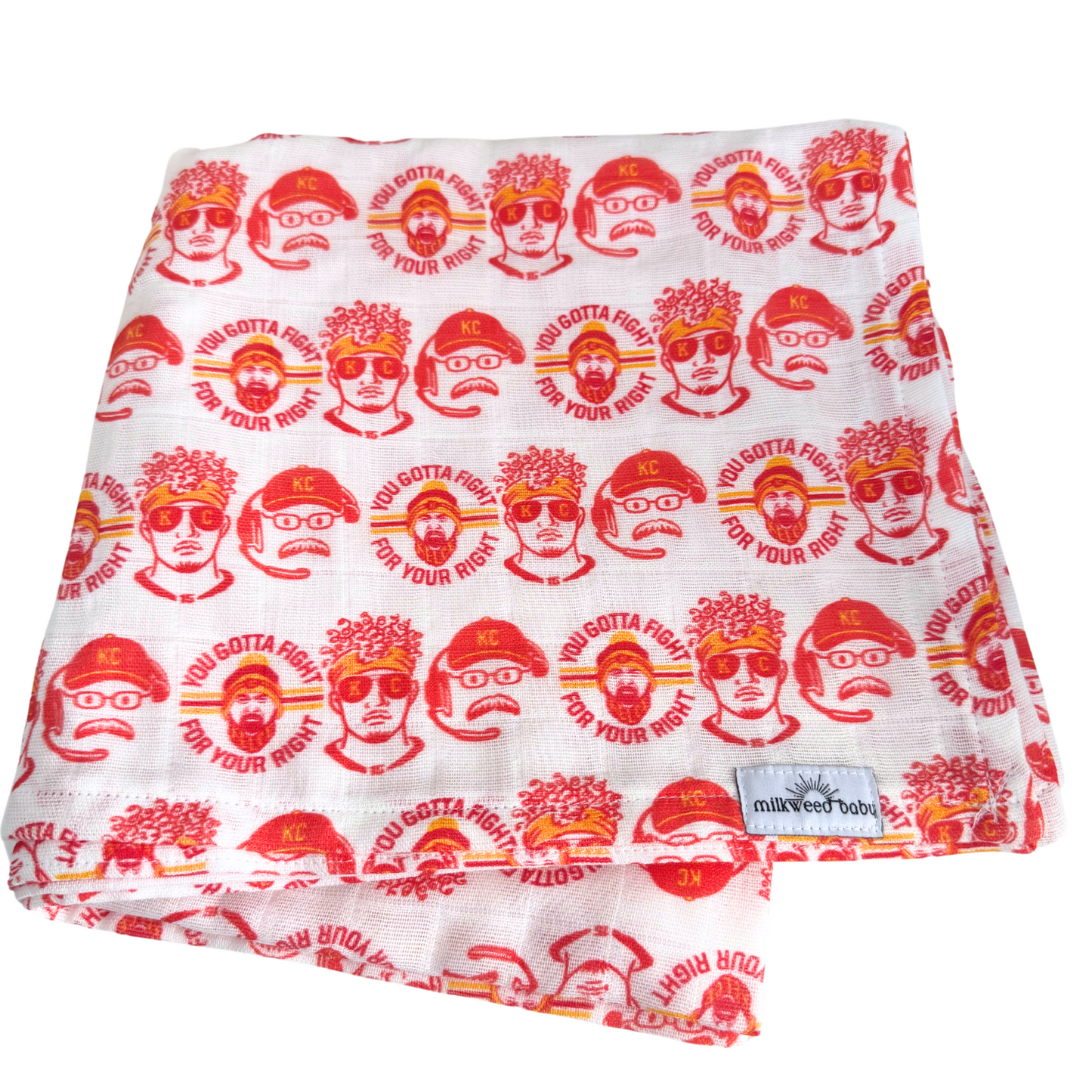 Folded KC Chiefs-themed baby swaddle blanket featuring Patrick Mahomes, Travis Kelce, and Coach Andy Reid, with red and yellow illustrations on soft, organic Sweet Pea Gauze fabric.