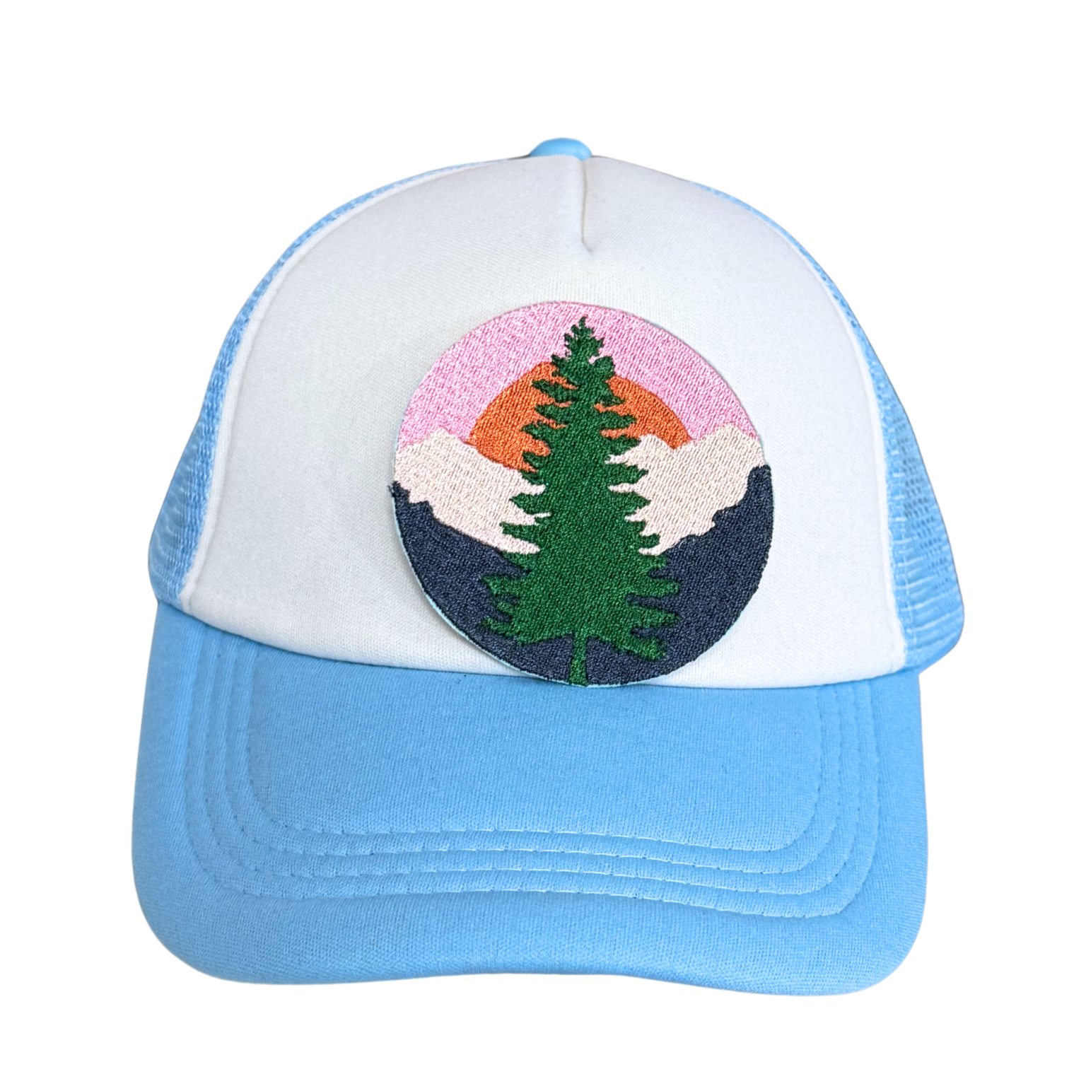 Light blue and white trucker hat with an embroidered mountain sunset pine tree patch attached.

