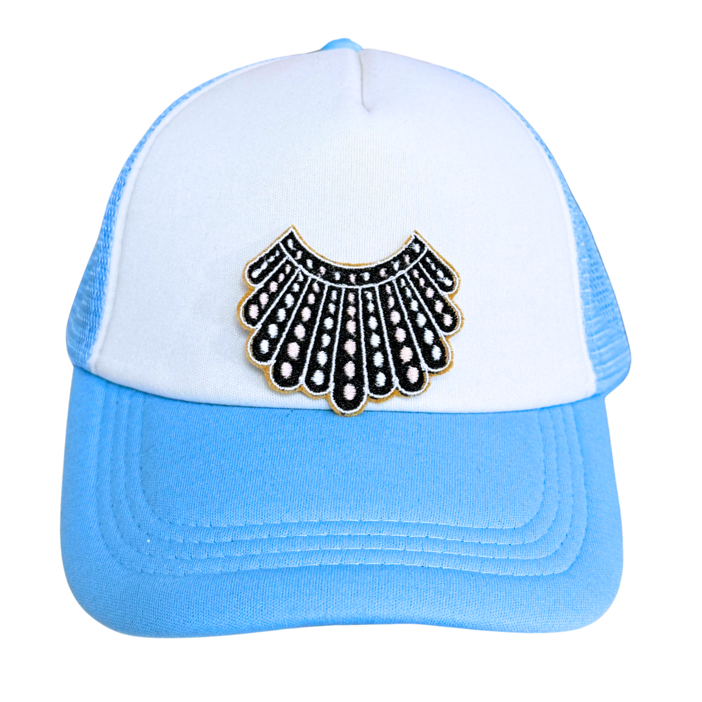 Light blue and white trucker hat with an embroidered dissent collar patch attached.

