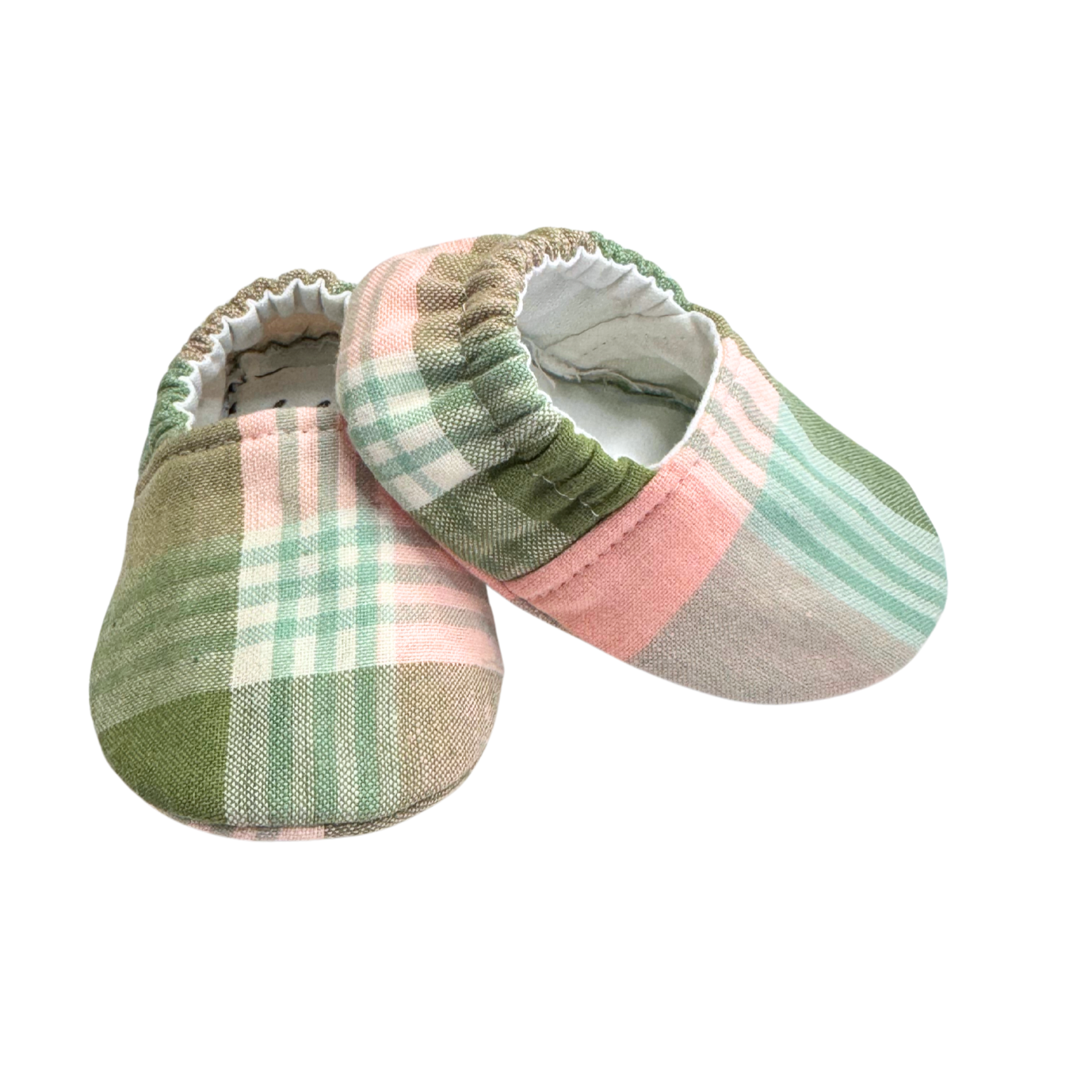 Side view of sage plaid baby moccasins, showcasing soft, breathable vegan fabric and a flexible sole for natural movement.