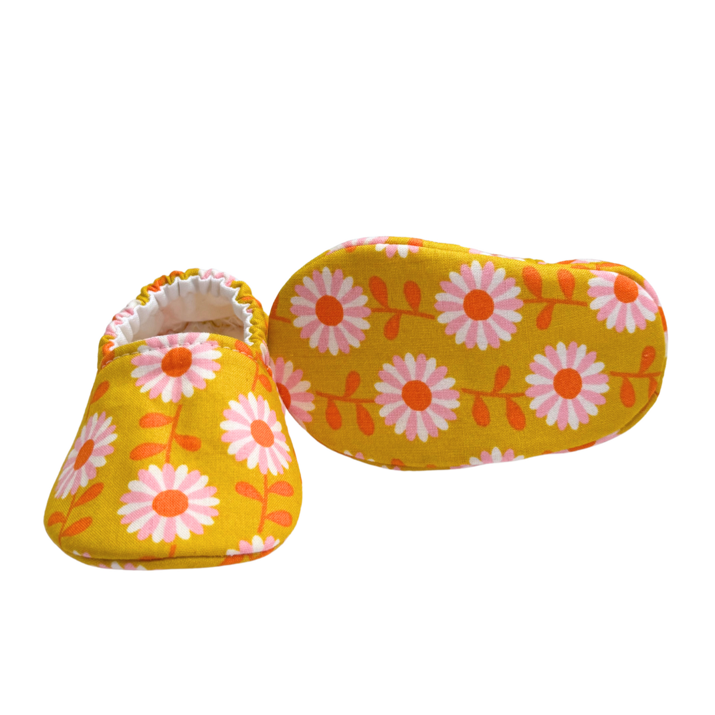 Bottom view of daisy baby moccasins, highlighting the soft, flexible soles designed for early foot development and all-day comfort.

