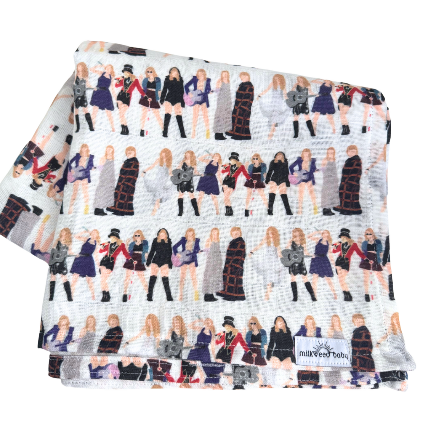 Folded Taylor Swift Eras Tour-inspired baby swaddle blanket, showing a repeating pattern of famous tour outfits in a lightweight, breathable organic gauze fabric.