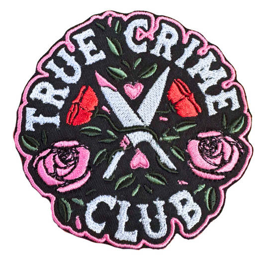 Handmade True Crime Club embroidered patch featuring crossed knives, roses, and gothic lettering on a black background.
