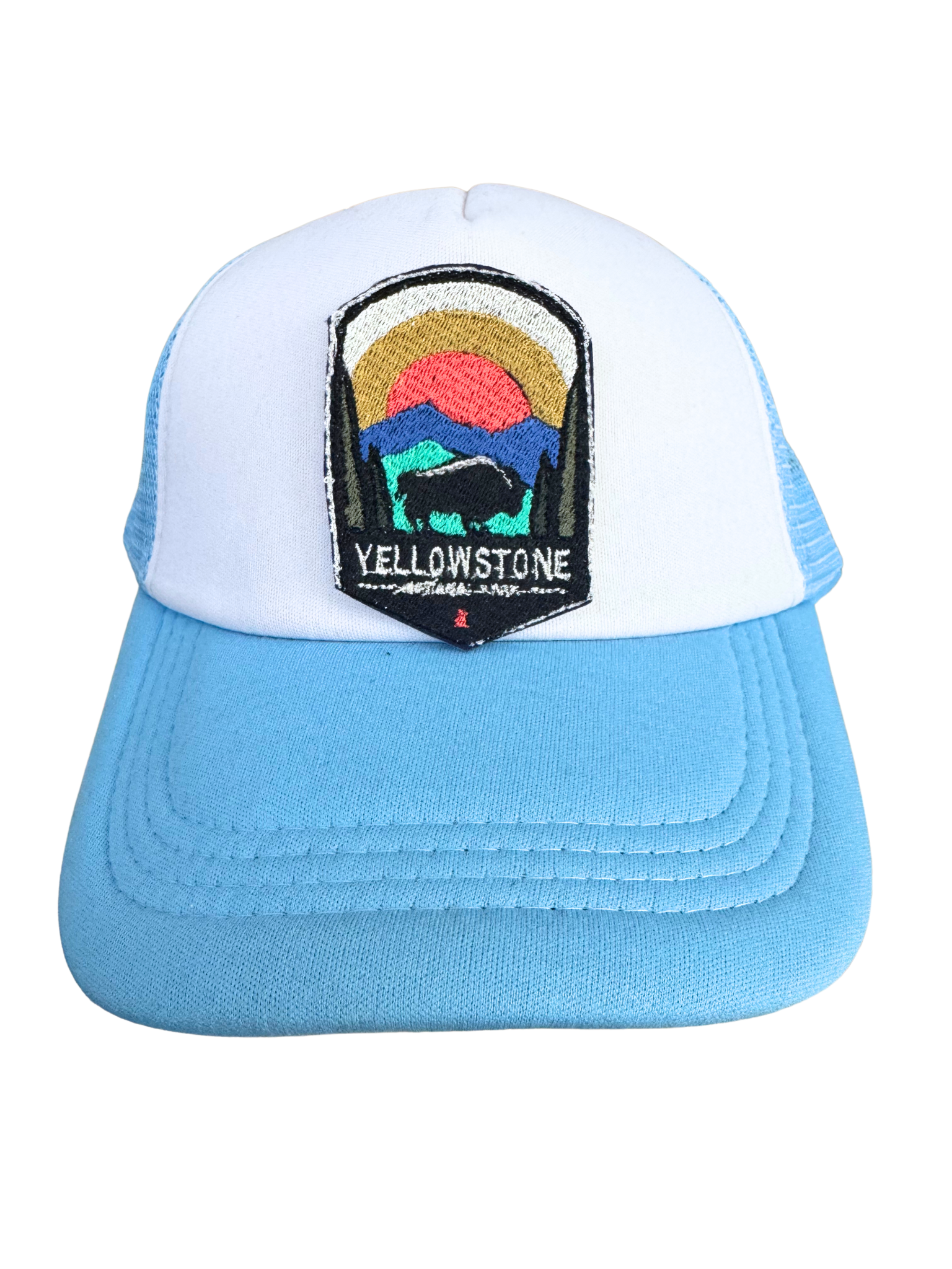 Blue and white trucker hat featuring the Yellowstone National Park embroidered patch, perfect for adventurers and outdoor lovers.
