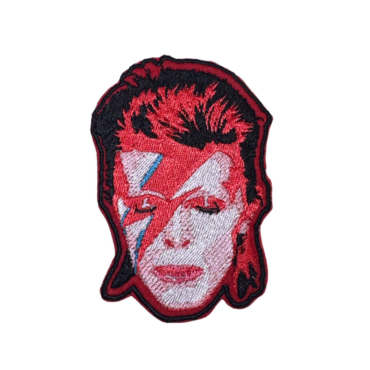 Close-up of the embroidered Ziggy Stardust patch featuring David Bowie's iconic red hair and lightning bolt makeup.
